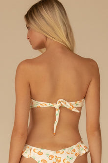 Strapless bandeau bikini top with cherry sherbet print and tie closure at back.