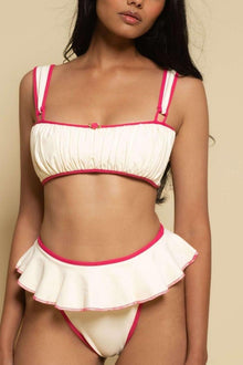 Cream bikini bottom with hot pink binding, ruffle skirt detail, and matching hot pink trim.