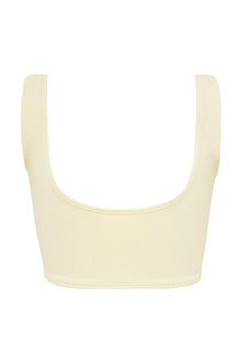 Cream ribbed bikini top with wide shoulder straps and scoop neckline, displayed flat against white background.
