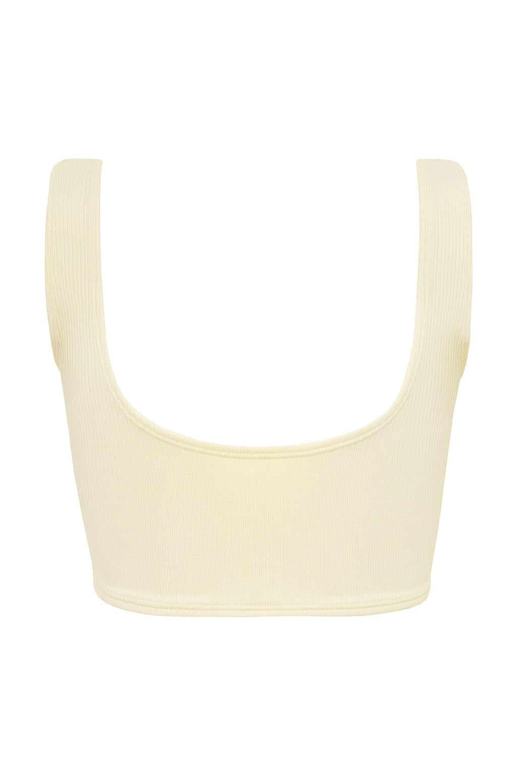 Cream ribbed bikini top with wide shoulder straps and scoop neckline, displayed flat against white background.
