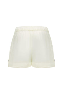 Cream lounge short with elastic waistband and folded cuffs, displayed flat against white background.