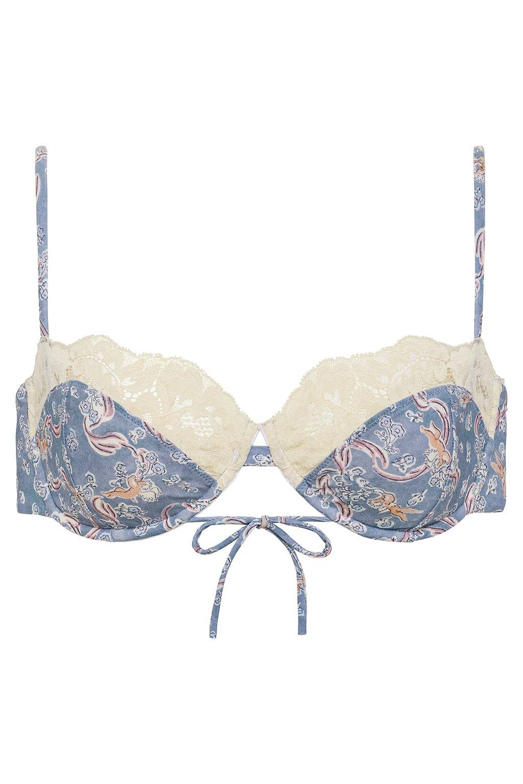 Blue patterned bikini top with cream lace trim, tie-front closure, and adjustable shoulder straps.