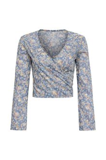 Blue wrap top with gold and rust paisley print, long sleeves, and V-neckline.