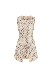 Sleeveless cream dress with small dark floral print and drawstring detail at center front hem.