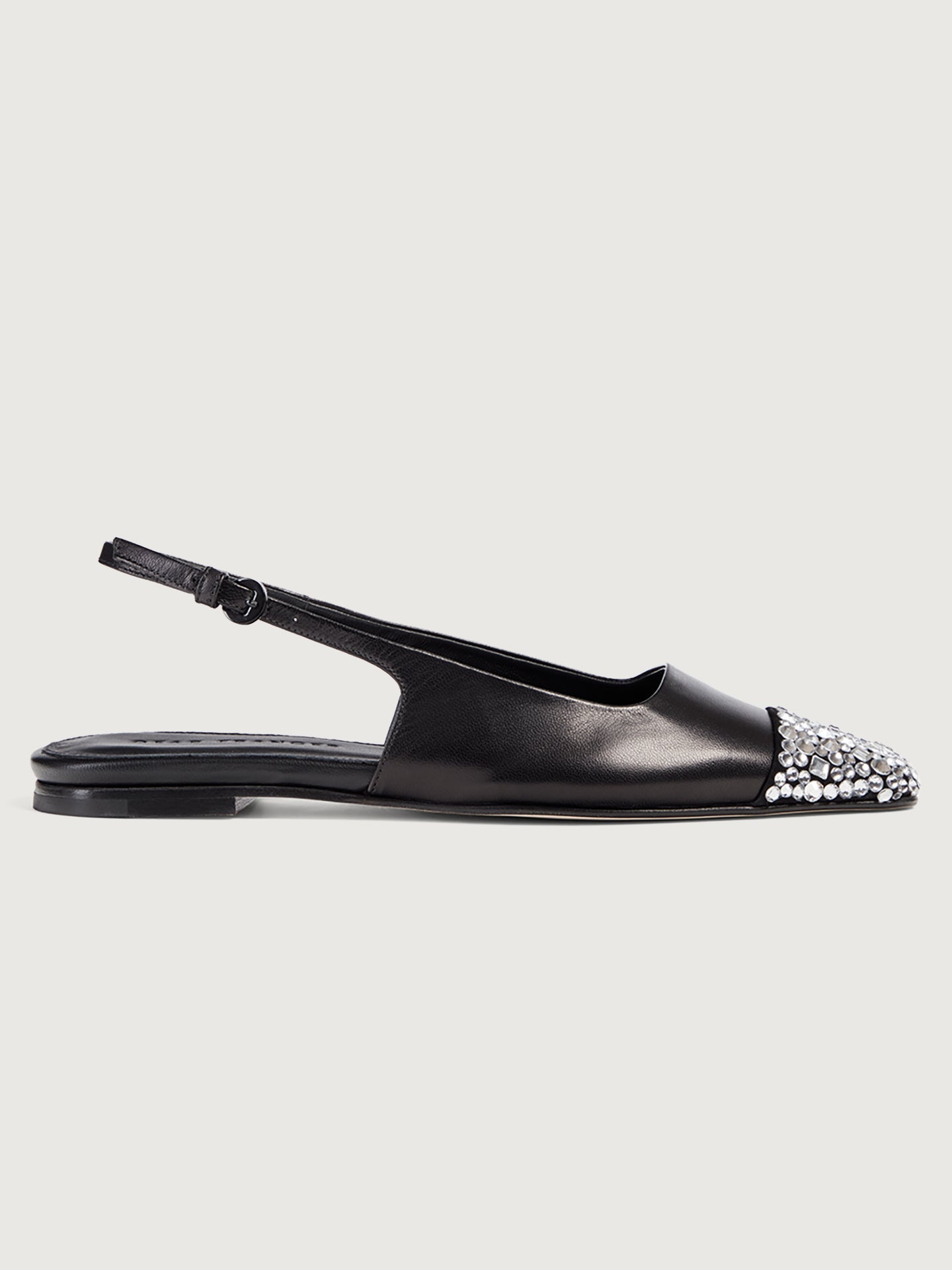 Black leather slingback flat with a sharp square-toe and crystals on the cap.