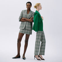 front image of a woman wearing the whitney skirt in check plaid