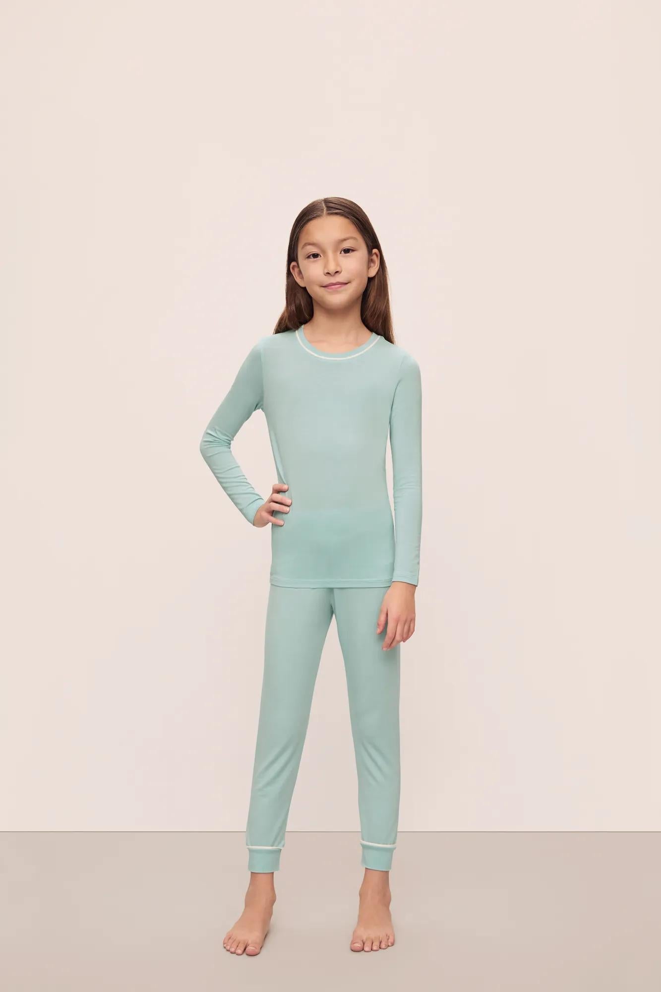 Model is wearing Kids Tencel Modal Unisex Long Pj Set in Canal Blue/Ivory