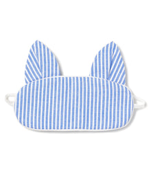 The Kids Kitty Sleep Mask in French Blue Seersucker by Petite Plume features cat-like ears and elastic straps for a snug fit. This playful mask can be monogrammed, making it an ideal gift. Consider matching masks for friends to share the cozy charm.