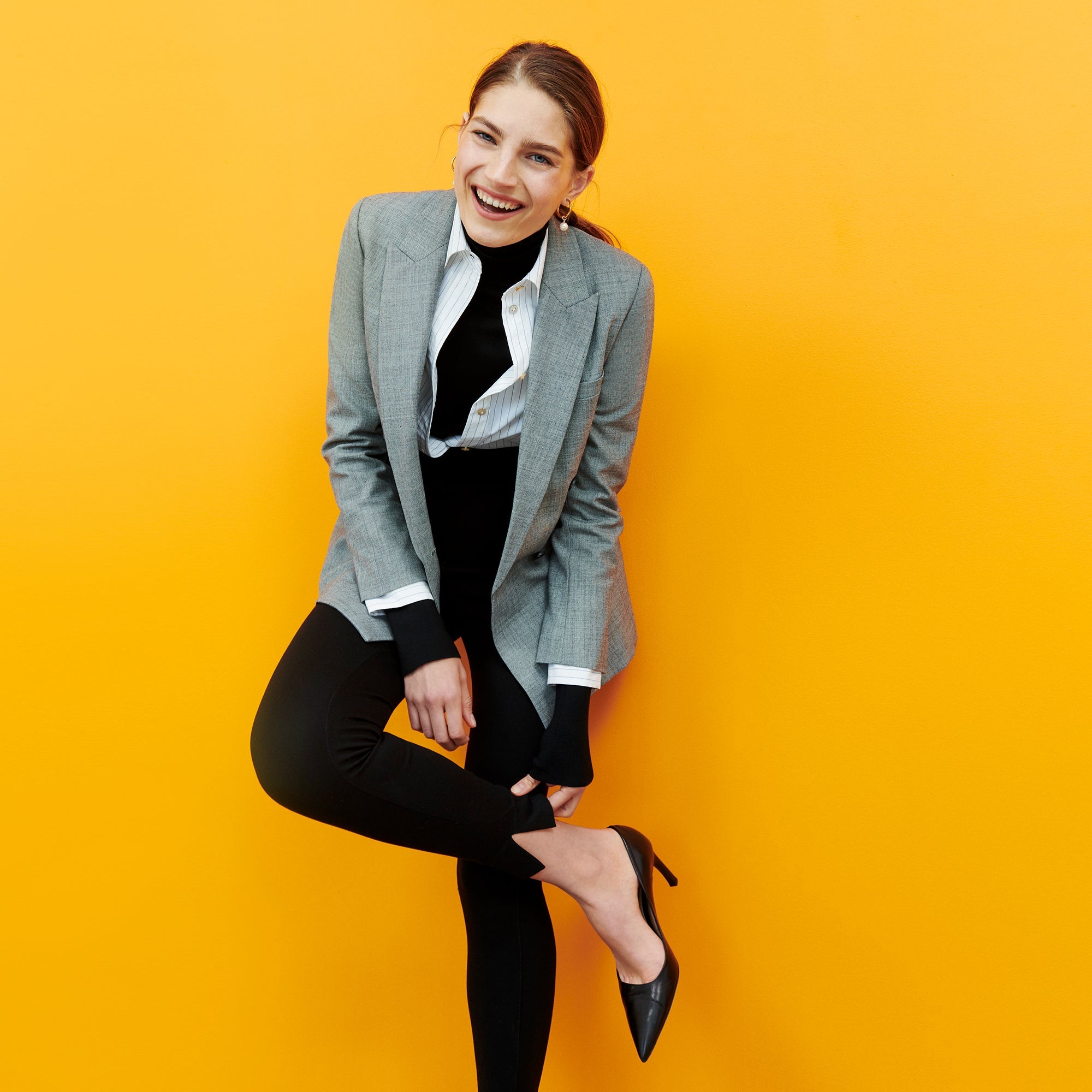 Front image of a woman standing wearing the curie pant in black
