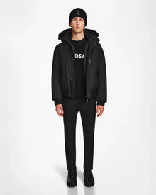 A man wearing the Rudsak DEACON - M123513 Black/Black RDS-certified down bomber puffer jacket and black pants.