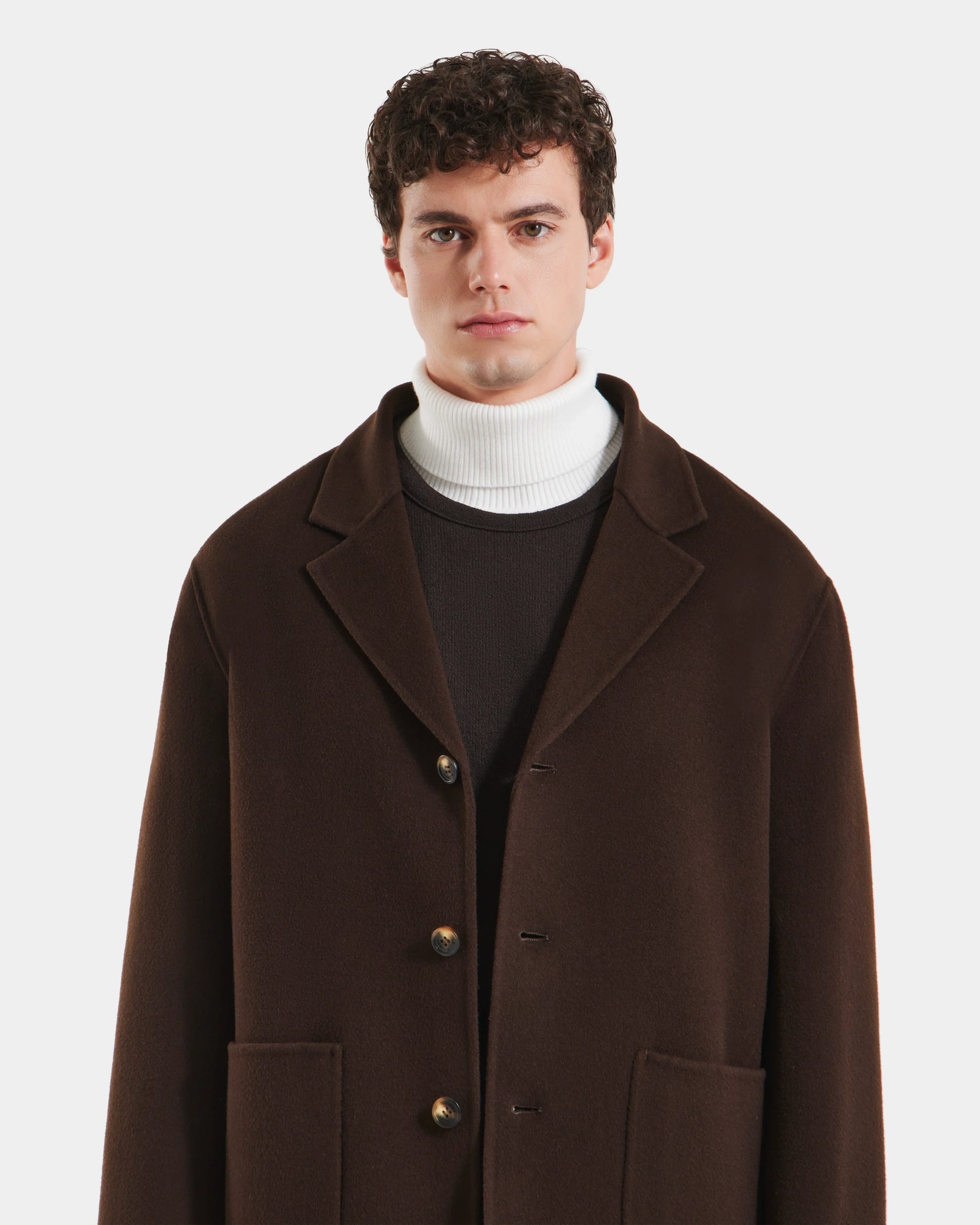 A man in the Rudsak AIDEN - 6125558 Espresso, a refined men’s wool-blend coat featuring a removable shearling collar.