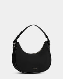 The NIKKI - L325512 Black by Rudsak is a black women’s crescent shoulder bag with a hobo silhouette, short adjustable strap, gold-tone hardware, zipper closure, and Rudsak printed in small gold letters near the bottom center.