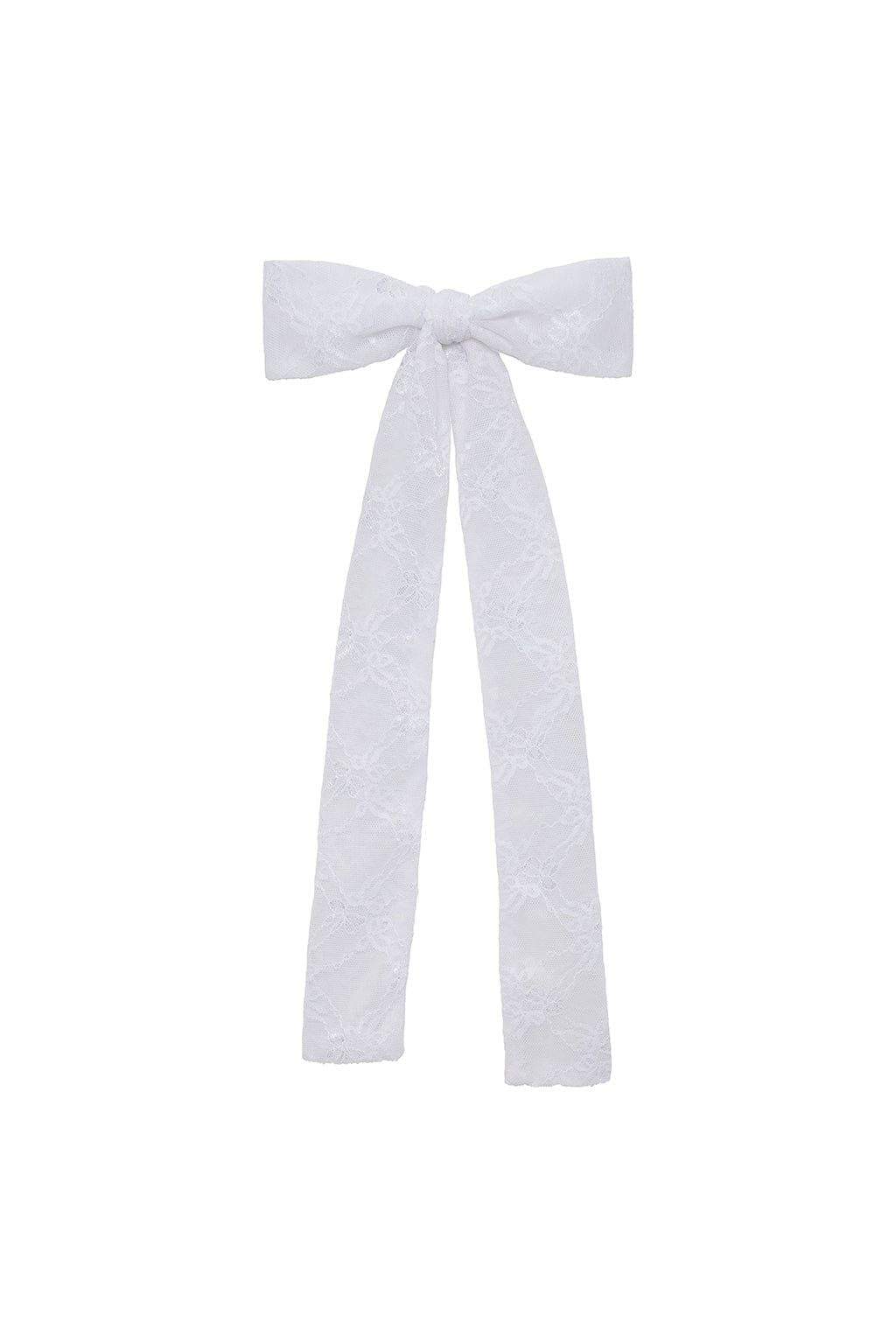 White lace bow ribbon with long trailing ends and textured floral pattern.