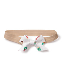 The Petite Plume Girls Hair Bows in Winter Nostalgia make a charming holiday gift with their beige base and playful white bows adorned with green, red, and turquoise patterns. Perfect for stocking stuffers, this delightful accessory is presented flat on a white background.