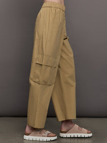 Model wears a pair of mid rise khaki cargo wide leg pants.