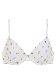 White bikini top with small blue and yellow floral print throughout, featuring thin shoulder straps and underwire cups.