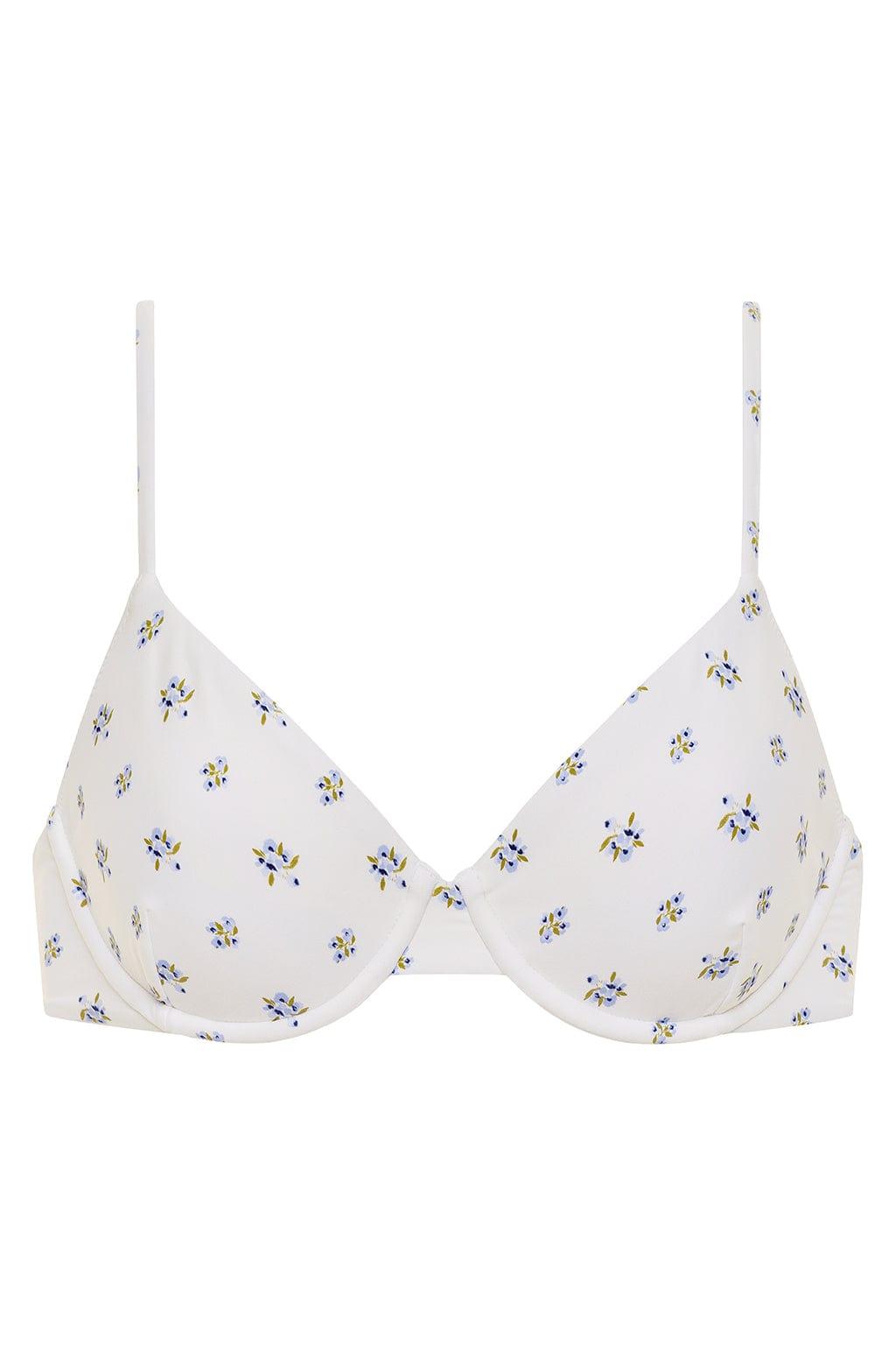 White bikini top with small blue and yellow floral print throughout, featuring thin shoulder straps and underwire cups.