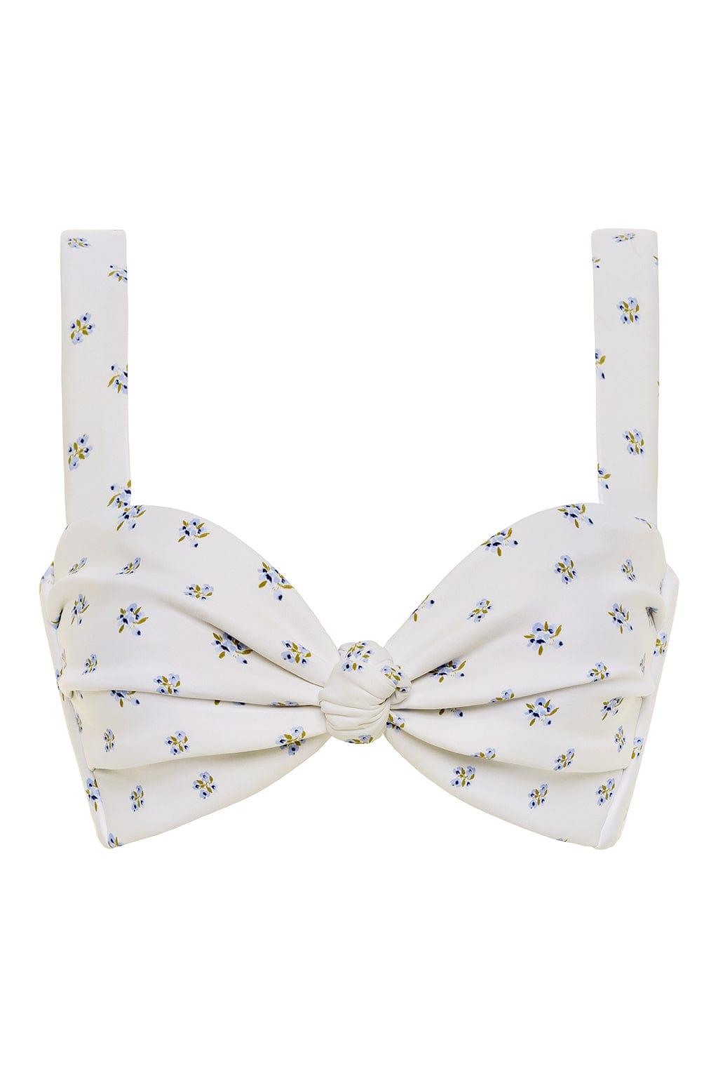 White bikini top with small blue and yellow floral print and bow-tie center detail with adjustable shoulder straps.
