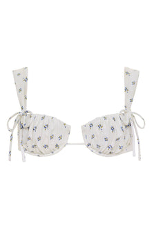 Cream bikini top with small blue and yellow floral print, wide shoulder straps, and side tie closures.