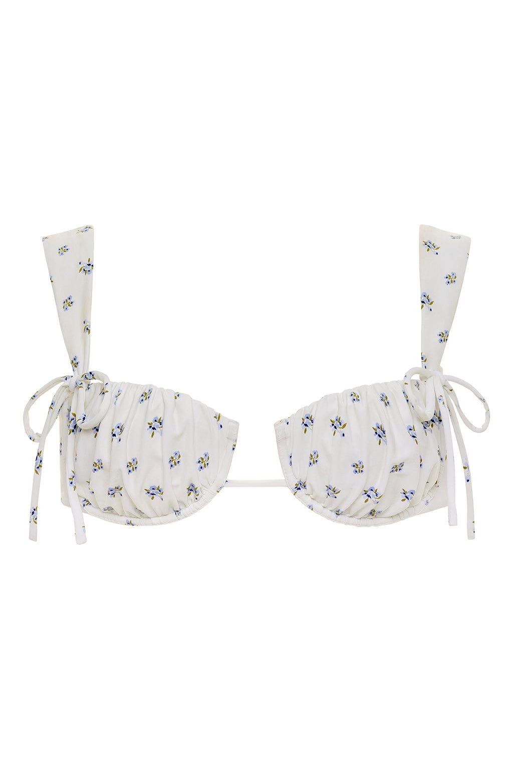 Cream bikini top with small blue and yellow floral print, wide shoulder straps, and side tie closures.