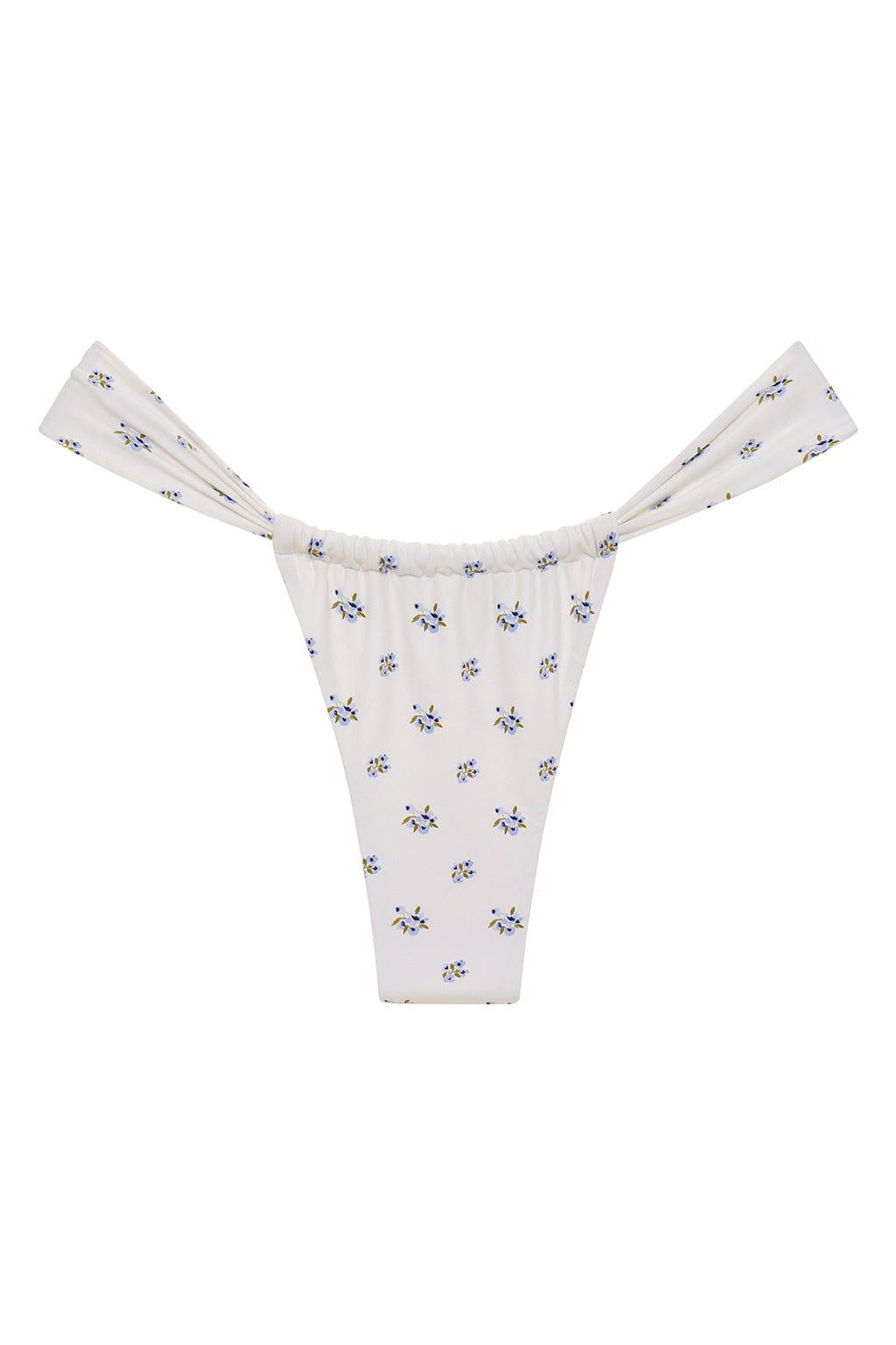 White bikini bottom with small blue and yellow floral print throughout and ruched side ties.