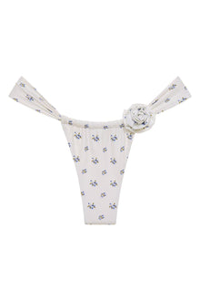 White bikini bottom with small blue and yellow floral print and decorative rosette detail at center waistband.