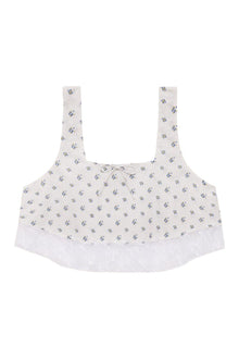 Cream crop top with small blue floral print, square neckline, wide straps, and white lace trim along the hem.