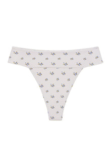 Cream bikini bottom with small scattered blue and yellow floral print throughout.