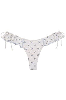 Cream bikini bottom with small blue and yellow floral print, ruffled trim on sides with bows and adjustable tie straps.