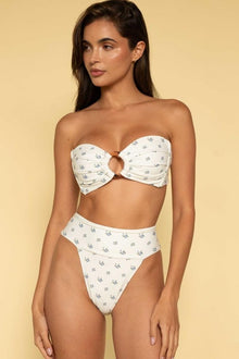 White bikini bottom with small floral print, high-waisted cut, worn with matching floral bikini top.