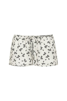 Cream drawstring shorts with black bandana print and decorative tie detail at waistband.