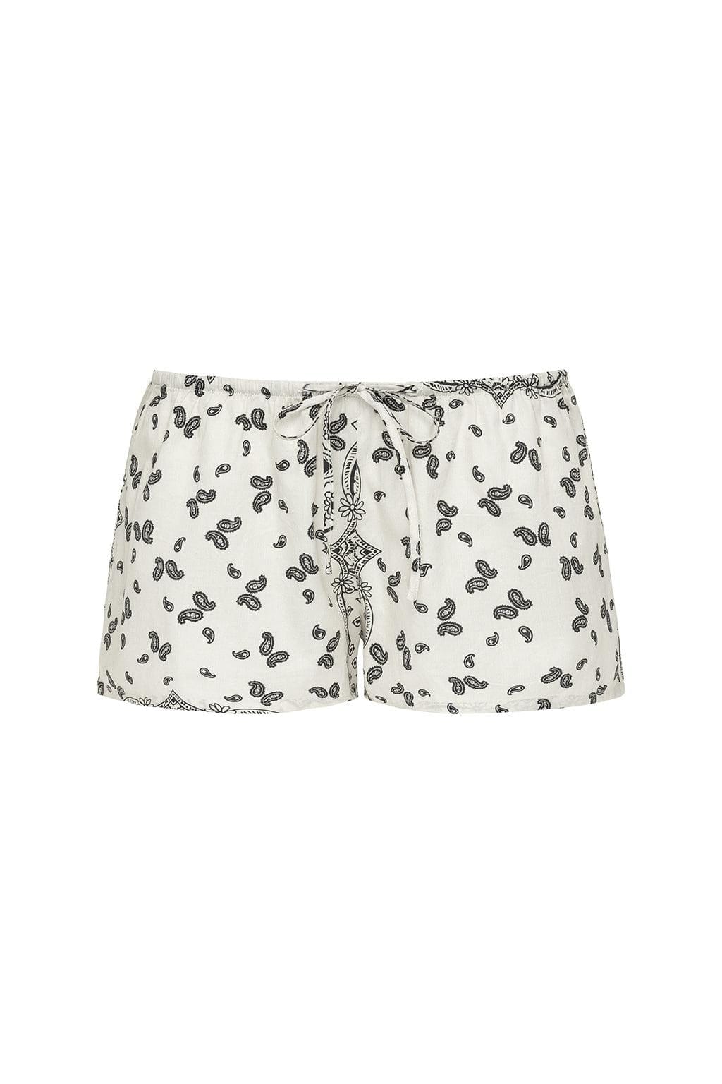 Cream drawstring shorts with black bandana print and decorative tie detail at waistband.