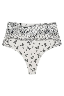 High-rise bikini bottom in cream with black bandana patterning featuring paisley and geometric designs.