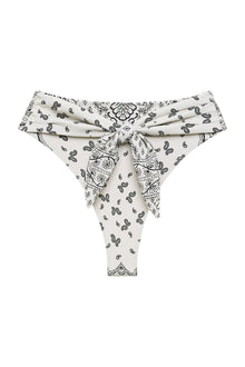 Cream bikini bottom with black bandana print and tie-up front closure.