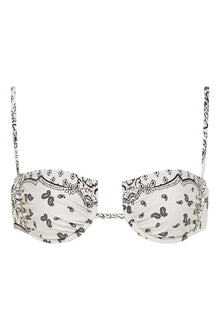 White bandana-print bikini top with black paisley and floral motifs, adjustable straps, and gathered cup detail.