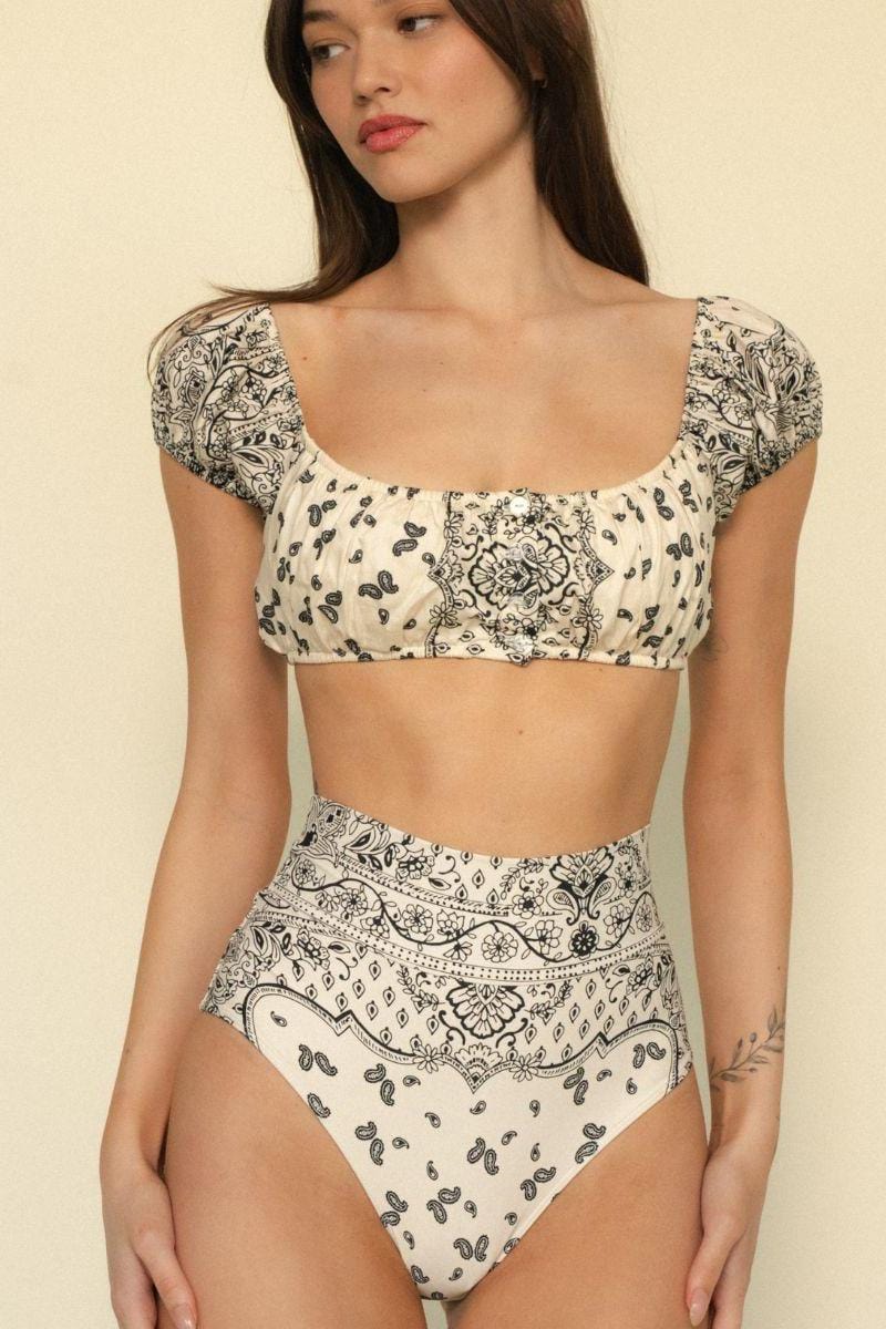 Cream bikini top with black bandana and paisley print, puffed short sleeves, scoop neckline.