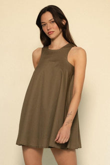 Khaki sleeveless dress with round neckline and A-line silhouette worn by model.