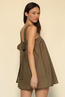 Khaki sleeveless dress with open back tie detail and A-line silhouette.