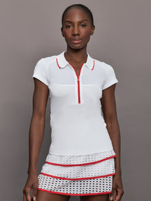 Model wears a mesh short sleeved lightweight tennis polo with red detailing.