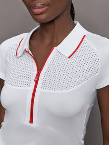 Model wears a mesh short sleeved lightweight tennis polo with red detailing.