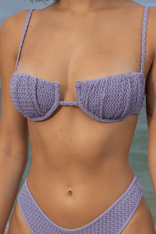 Lavender crochet bikini top with petal-shaped cups, thin straps, and center cutout detail.