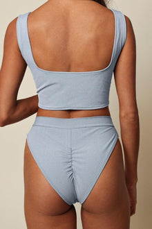Light blue denim corset crop top with square neckline and matching high-waisted bottoms, back view.