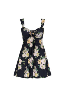Black sleeveless dress with yellow, pink, and white floral print, gold ring buckle detail at center chest, and A-line skirt.