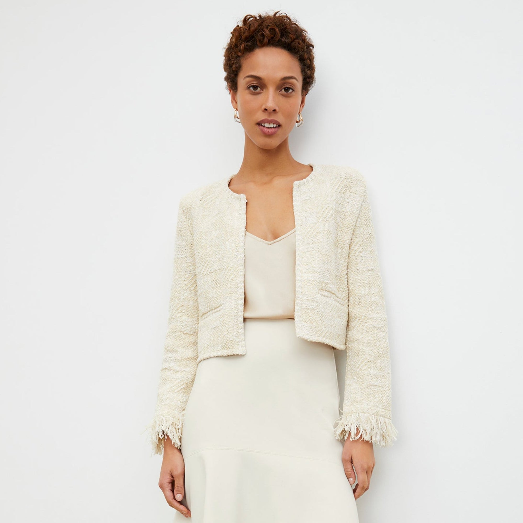 Front image of a woman standing wearing the lilia jacket in black and white | Lead