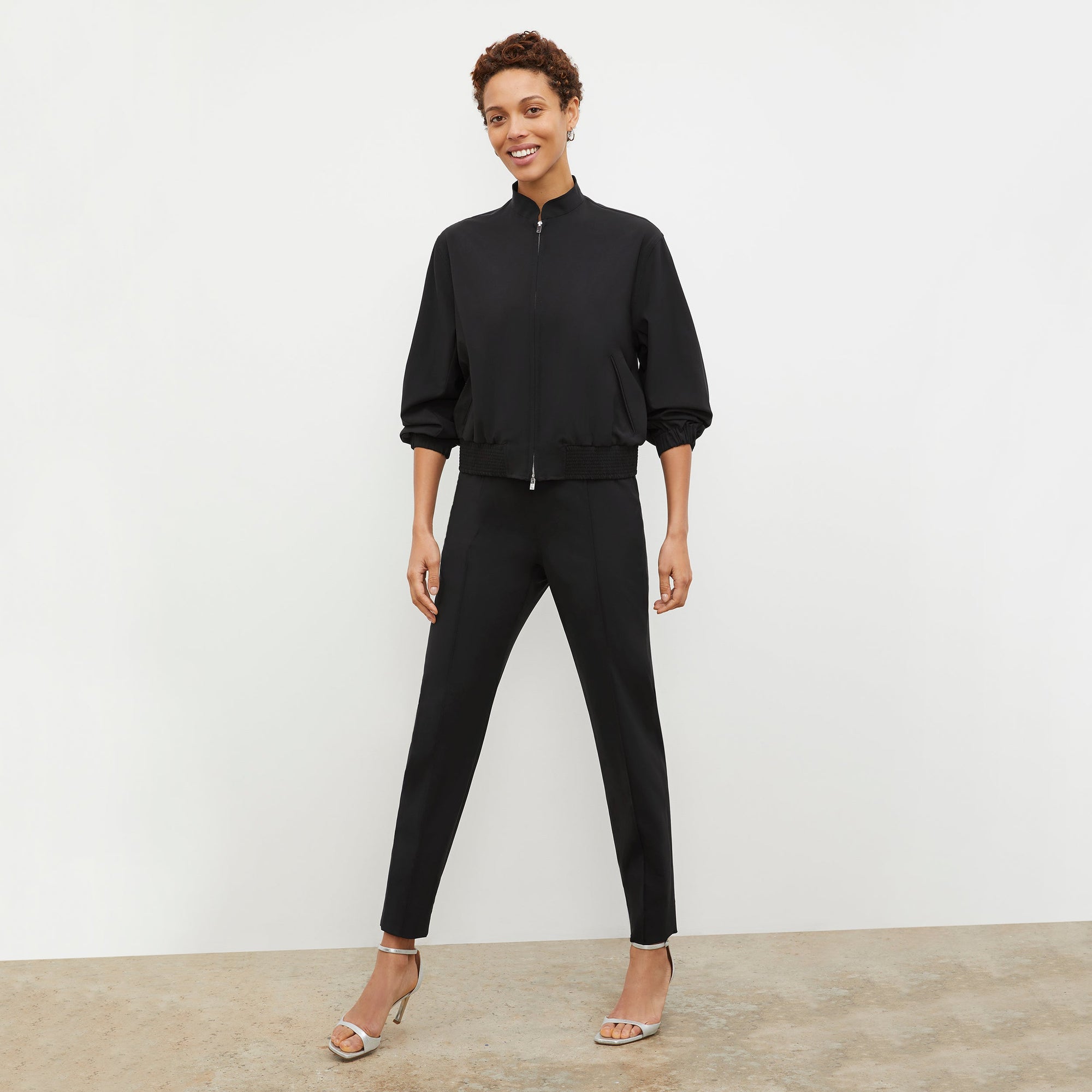 Front image of a woman standing wearing the Colby Jogger in Black | Exclude