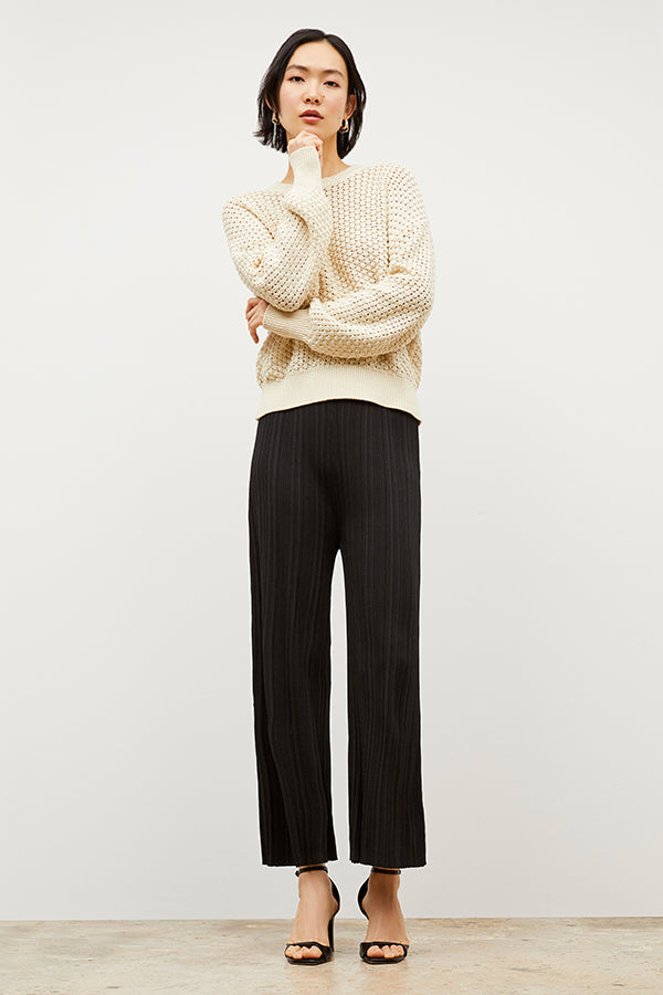 Side image of a woman wearing the Marijane Pant - Textured Knit in Black | Exclude | Grid