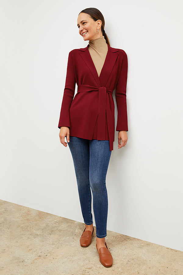 Front image of a woman standing wearing the axam top in camel | Exclude