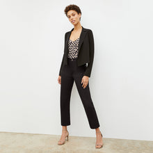 Front image of a woman standing wearing the Lisey Cami—Sahara Print Washable Silk in Tan/Black