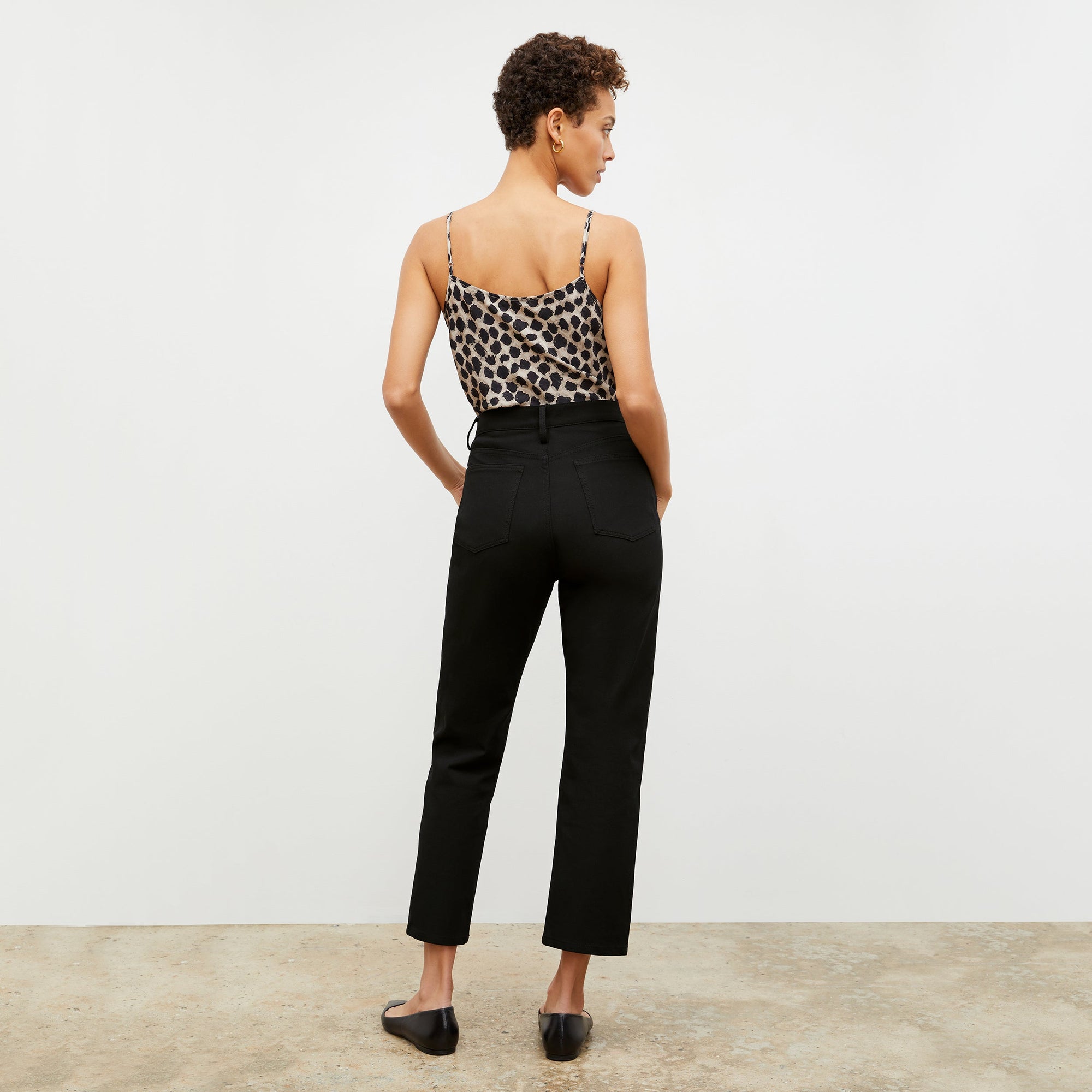 Back image of a woman standing wearing the Lisey Cami—Sahara Print Washable Silk in Tan/Black