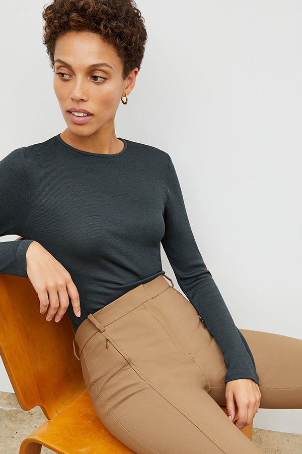 Front image of a woman standing wearing the Curie Pant—Everstretch in Saddle | Exclude